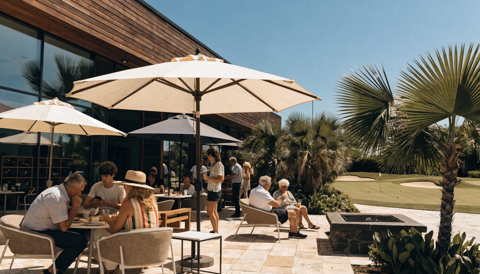 The clubhouse patio with people on a sunny day
